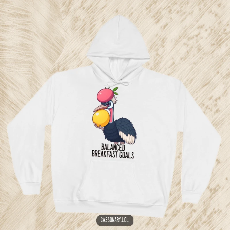 Funny Cassowary hoodie featuring a cassowary trying to balance a large fruit on its head, offering warmth and humor.
