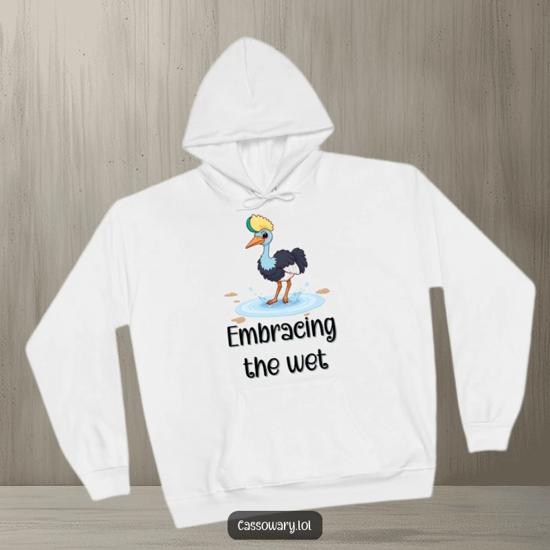 Funny cassowary hoodie with a bird playfully splashing in a small puddle with a happy splash, cozy and fun.