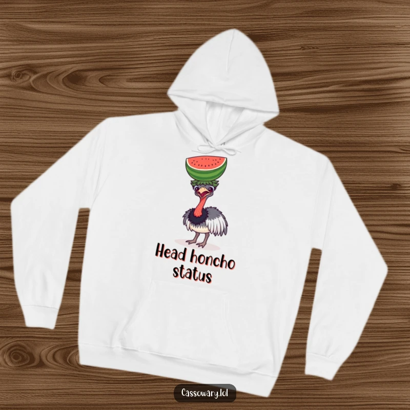 Funny hoodie showing a determined cassowary comically attempting to balance a watermelon on its head, offering warmth and humor.