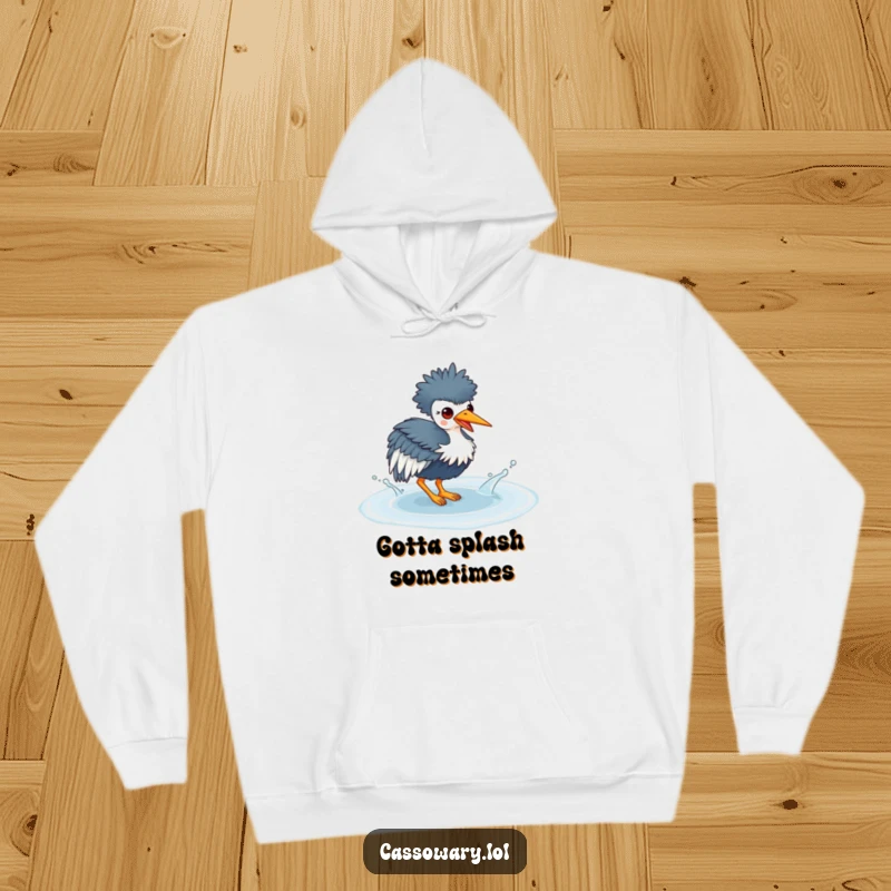 Funny hoodie depicting a kawaii cassowary playfully splashing water in a puddle, radiating joy and a love for wet adventures.