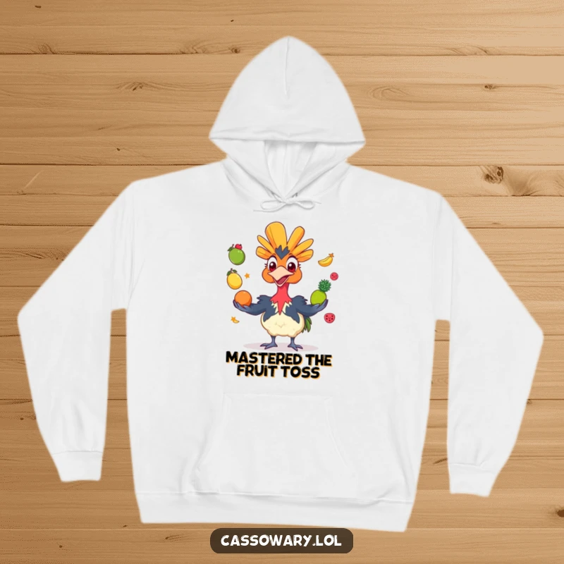 Funny cassowary hoodie showing a grinning bird juggling colorful fruits, offering cozy comfort with a humorous and vibrant design.