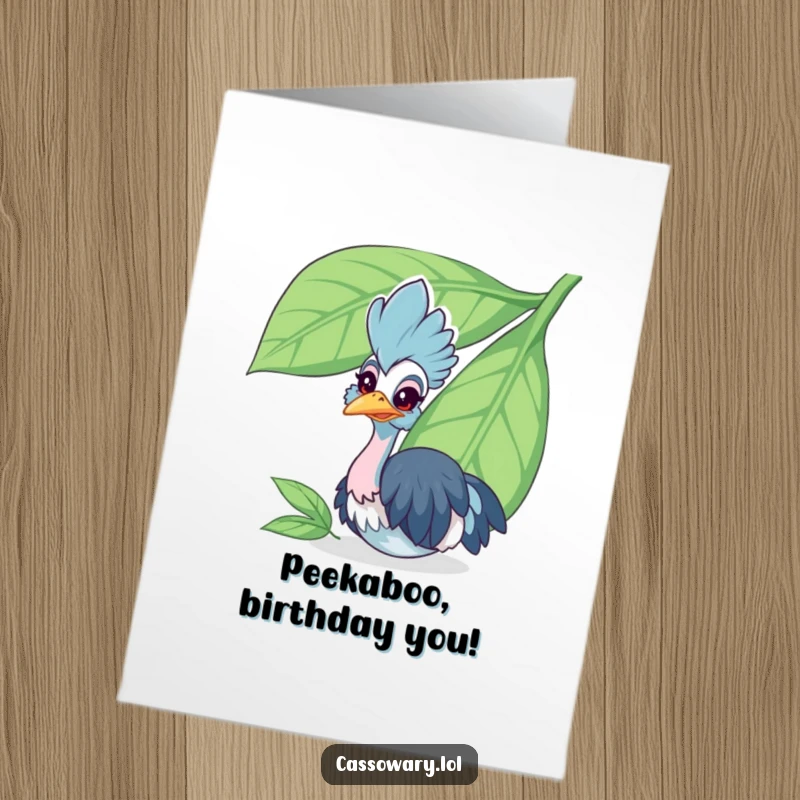 Funny Free Printable Birthday Card: Cheerful cassowary peeking from behind a large leaf, full of birthday mischief.
