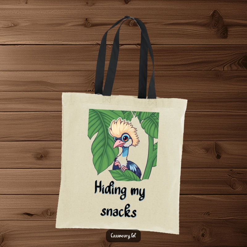 Funny cassowary tote bag with a playful cassowary peeking from behind a lush tropical leaf, ideal for everyday use.